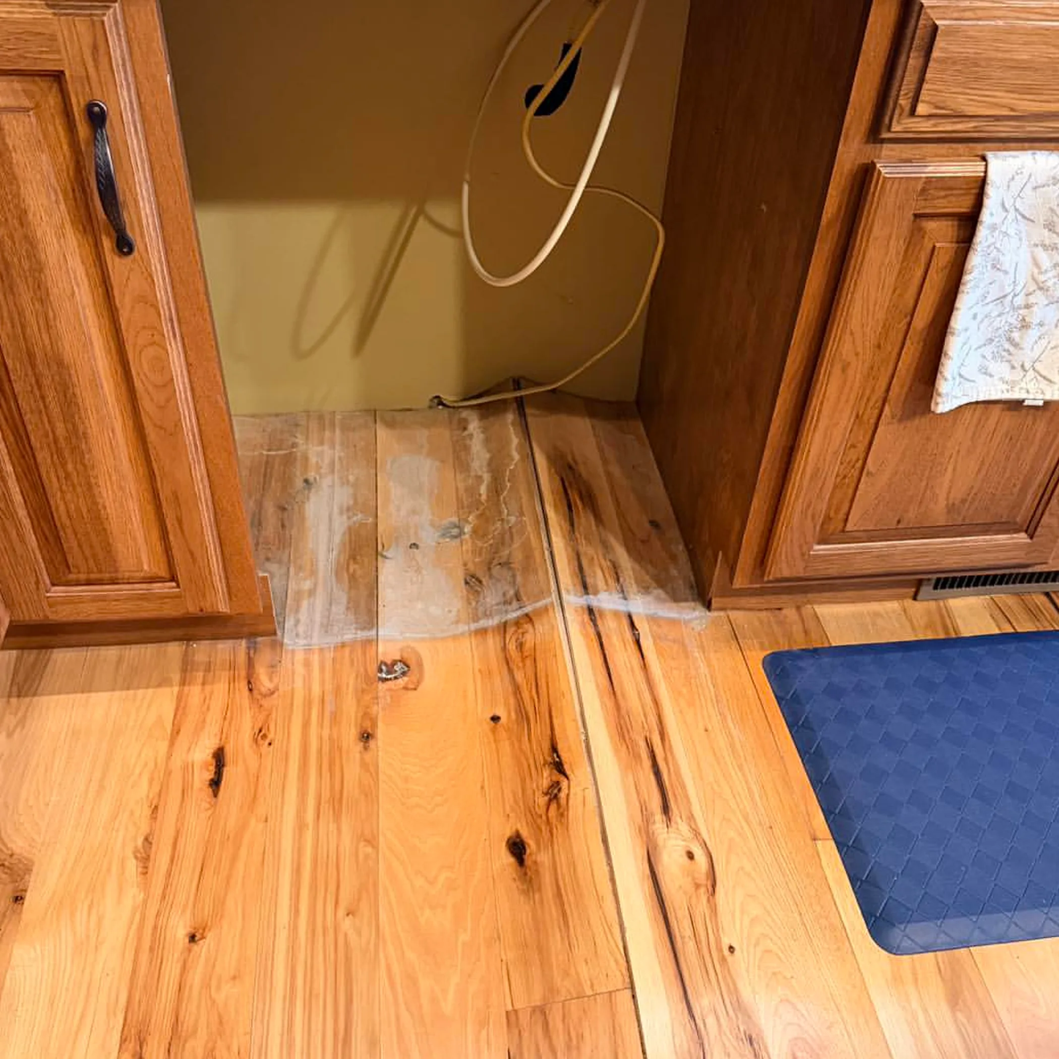plumbing leak damage on hardwood floor